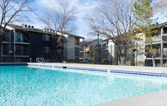 a swimming pool with apartments in the background