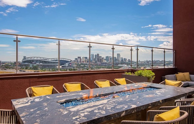 a view of the city from a terrace with a table and chairs