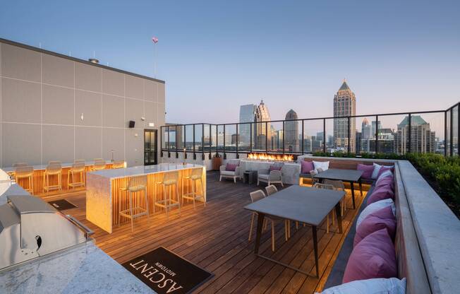 Rooftop lounge with outdoor kitchen, fireplace & spectacular views.