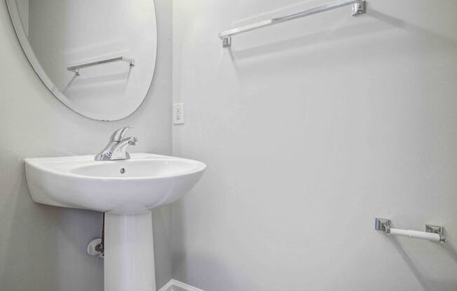 a white bathroom with a sink and a mirror