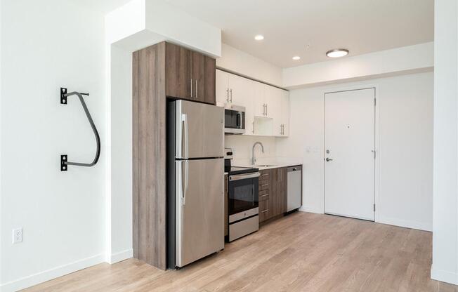 a kitchen with stainless steel appliances and a wood floor