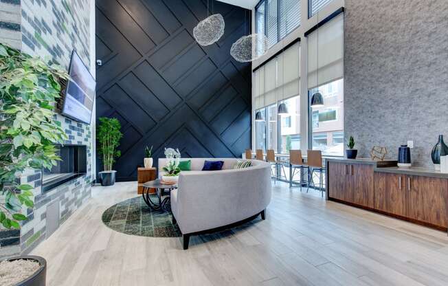 a living room with a couch and a table in front of a fireplace