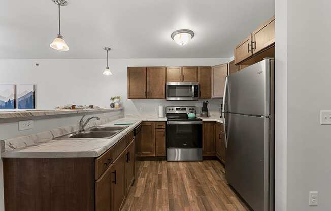 a kitchen with stainless steel appliances and wooden cabinets