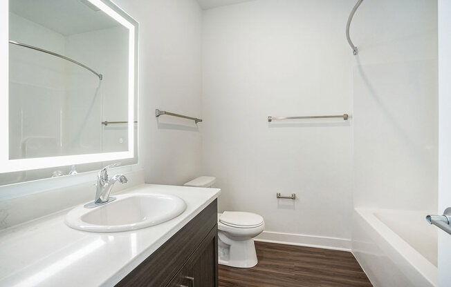 a bathroom with a sink toilet and bathtub at Meadowbrooke Apartment Homes, Grand Rapids, Michigan