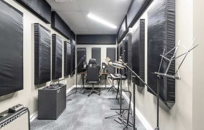 a recording studio with a variety of instruments and microphones