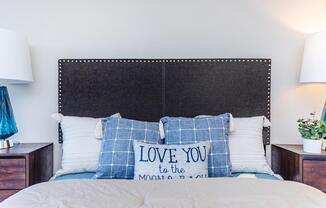 a bedroom with a bed and desk in a room