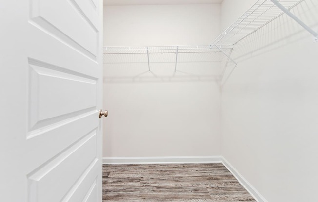 an empty closet in a home with a white door