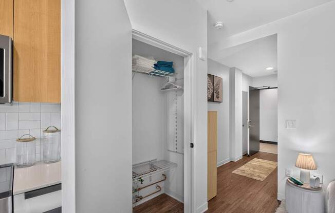 A white hallway with a rug and a lamp on the right.