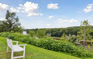 A white bench overlooking the Mississippi river at The Riverwood, Minnesota