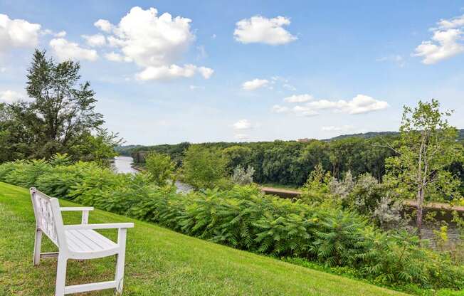 A white bench overlooking the Mississippi river at The Riverwood, Minnesota