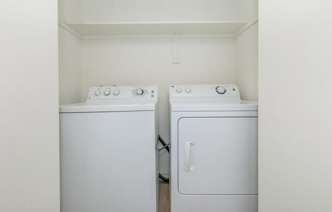 a microwave oven sitting on top of a refrigerator