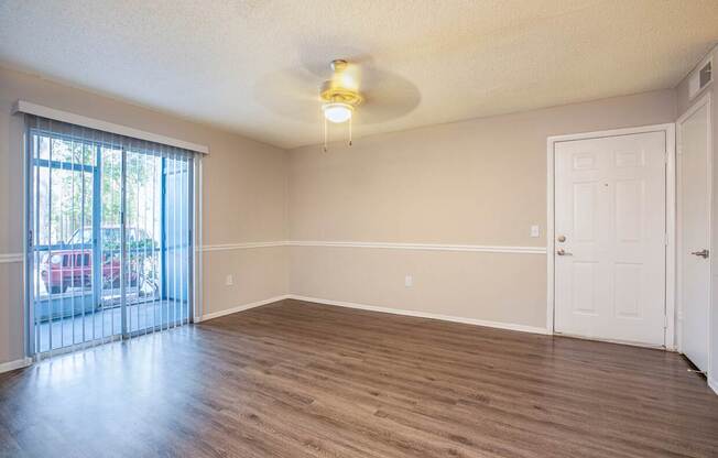 A room with a sliding glass door and a white door.