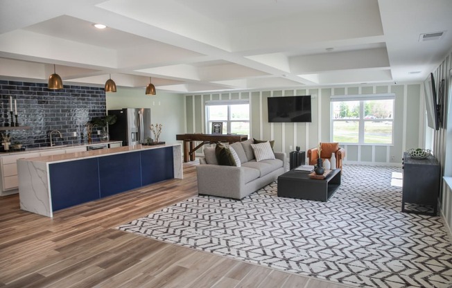 a living room with hardwood floors and a large rug