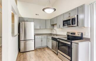 a kitchen with stainless steel appliances and white cabinets