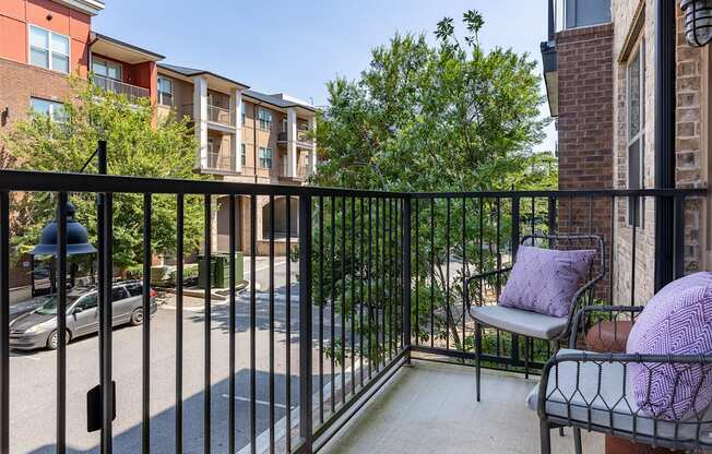 our apartments have a balcony with a chair and a table
