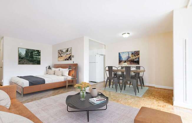 A living room with a couch, a coffee table, and a dining table.