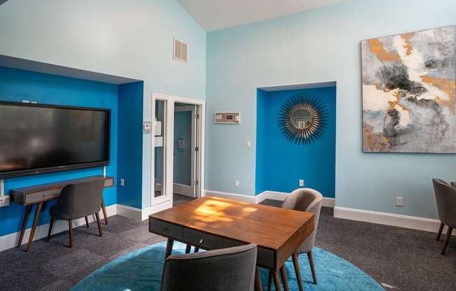 a living room with a tv and a table and chairs