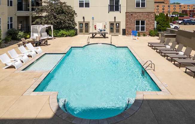 A large rectangular pool with a concrete floor and a concrete wall surrounding it.