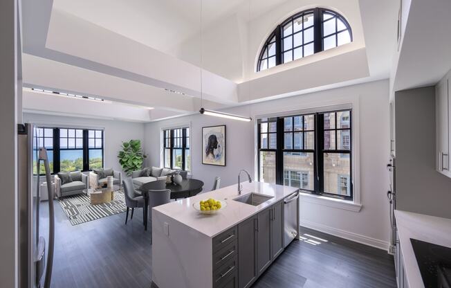 a kitchen and living room with a large arched window  at The Belden Stratford, Chicago