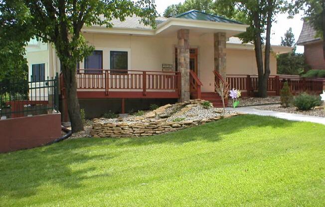 The exterior of the Cedar Ridge Apartments clubhouse with green grass in the foreground.