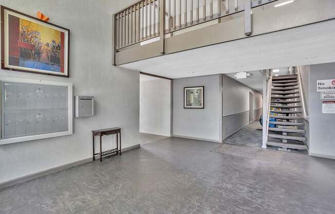 A room with a staircase and a no smoking sign.