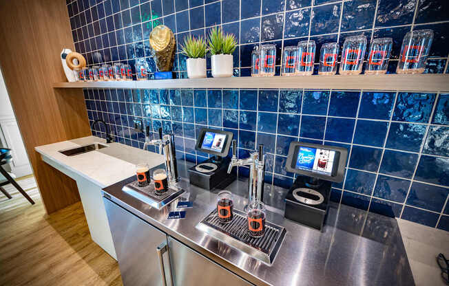 a kitchen with a counter with coffee machines and a tv