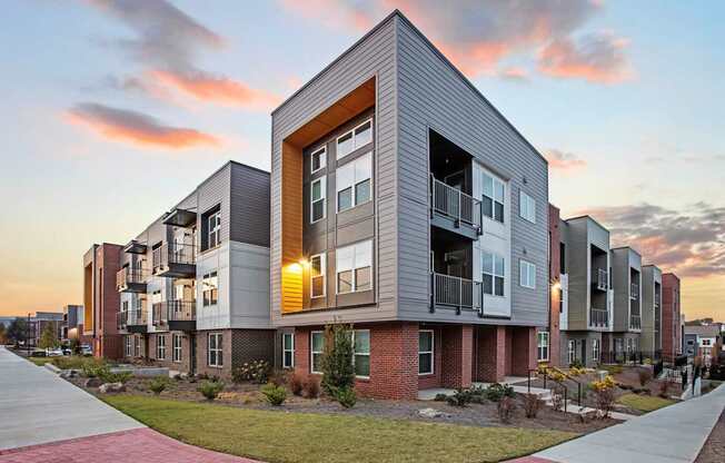 A modern apartment building with a mix of brick and panel exterior walls.