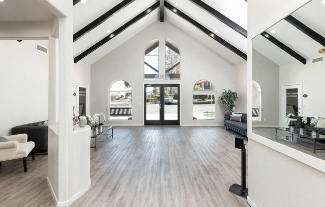 the living room of a new home with white walls and wood floors