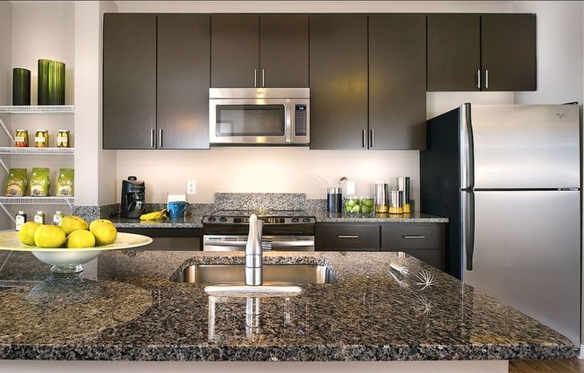 Kitchens with Granite Countertops, Islands, Stainless Steel Appliances and Wood-Style Flooring