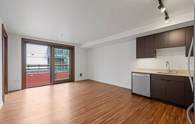 A kitchen area with a sink and a refrigerator.