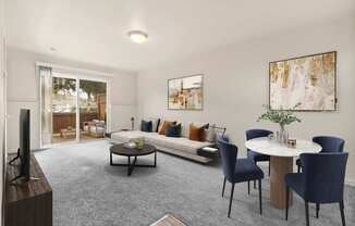 A living room with a grey carpet and a white table.