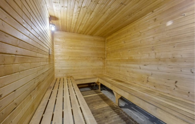 a sauna with wooden walls and wooden benches