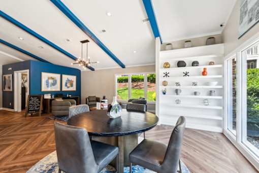 A modern dining room with a round table and chairs.