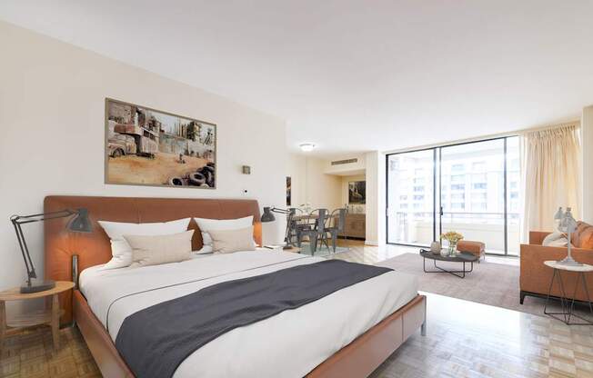 A bedroom with a large bed and a painting on the wall.