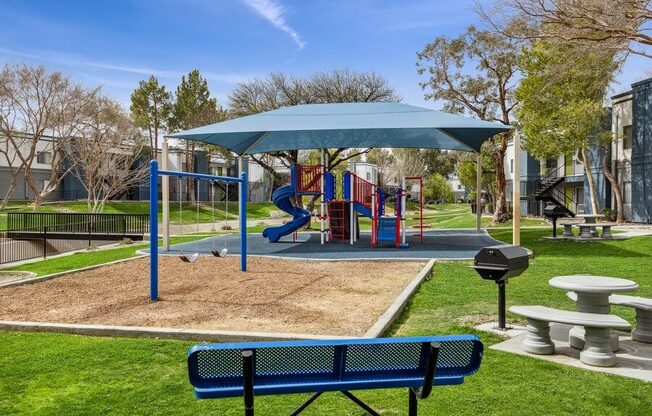 a playground with a slide and picnic table