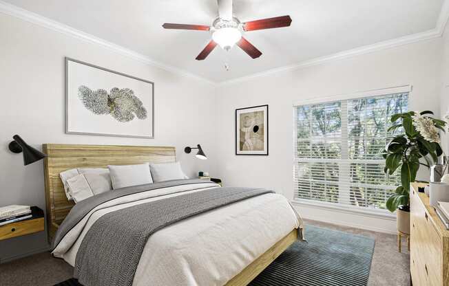 a bedroom with a bed and a ceiling fan