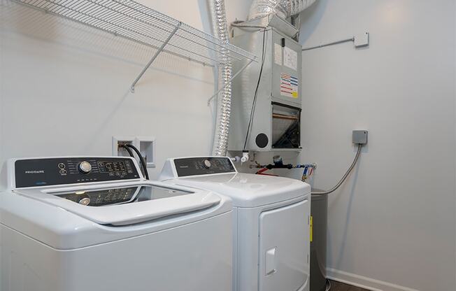 a laundry room with two washes and a dryer