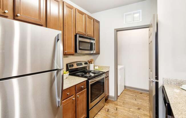 a kitchen with stainless steel appliances and wooden cabinets