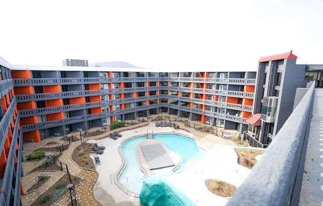 A large outdoor pool surrounded by a building.