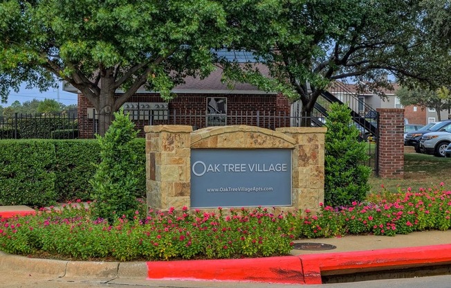 Oak Tree Village Apartments Exterior Front of Building and Sign