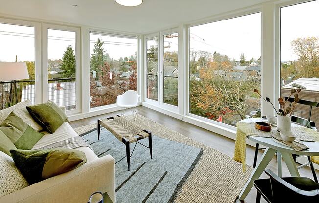 Living room with view of city and trees.at 19th & Mercer, Seattle, 98112