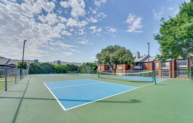 the preserve at ballantyne commons tennis court with trees and buildings in the background