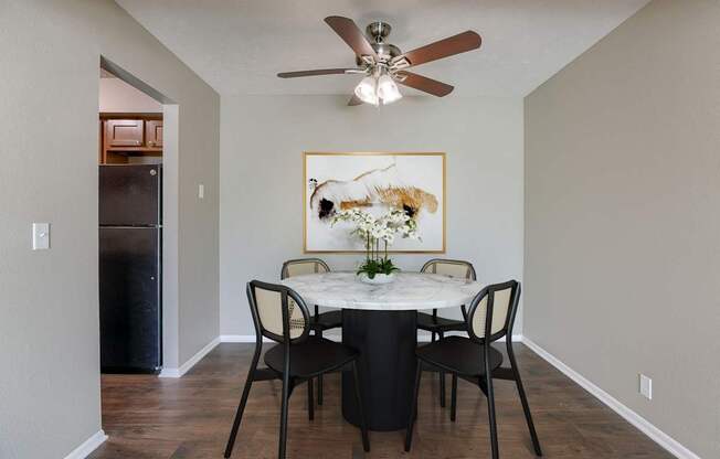 A dining room with a table set for four. Omaha, NE Evergreen Terrace Apartments