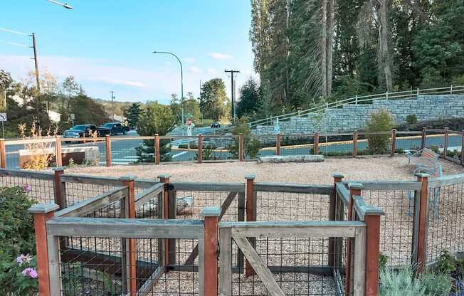 A playground with a wooden structure and a fence.