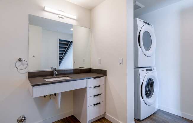 a bathroom with a sink and a washer and dryer at Marina Square, Washington