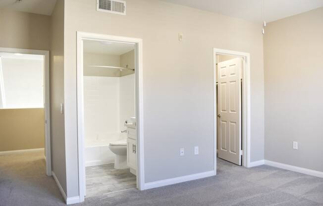 view of bedroom with closet and bathroom