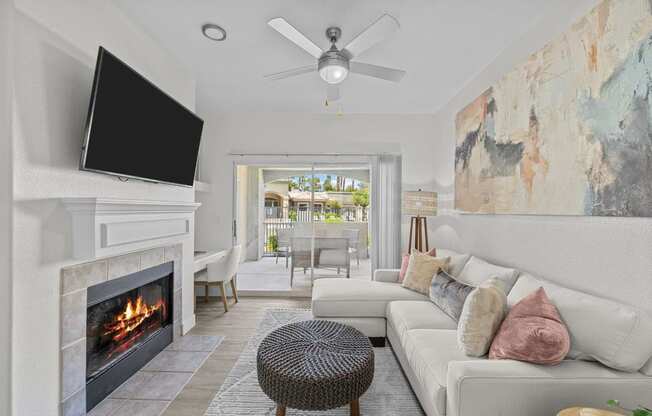 a living room with a fireplace and a tv