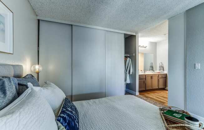 a bedroom with a large bed and a bathroom with a sink at Aspire Upland Apartments, Upland, 91786