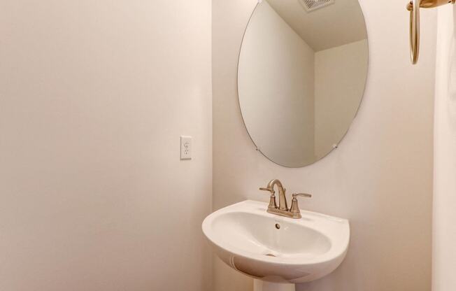 a small bathroom with a sink and a mirror