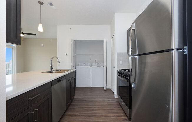 Kitchen with Washer & Dryer at Meadowbrooke Apartment Homes in Kentwood, MI 49512